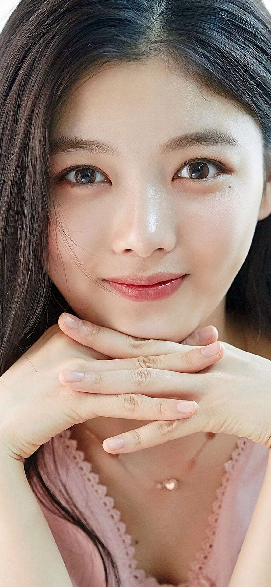 Kim Yoo Jung Close-Up Portrait with Soft Smile and Hands Under Chin HD phone wallpaper