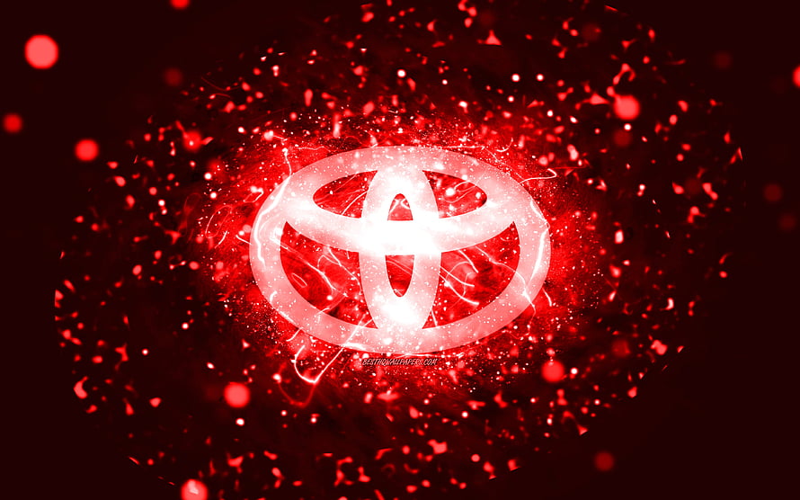 Glowing Toyota Emblem Surrounded by Vibrant Red Particle Explosion and Neon Light Effects HD wallpaper