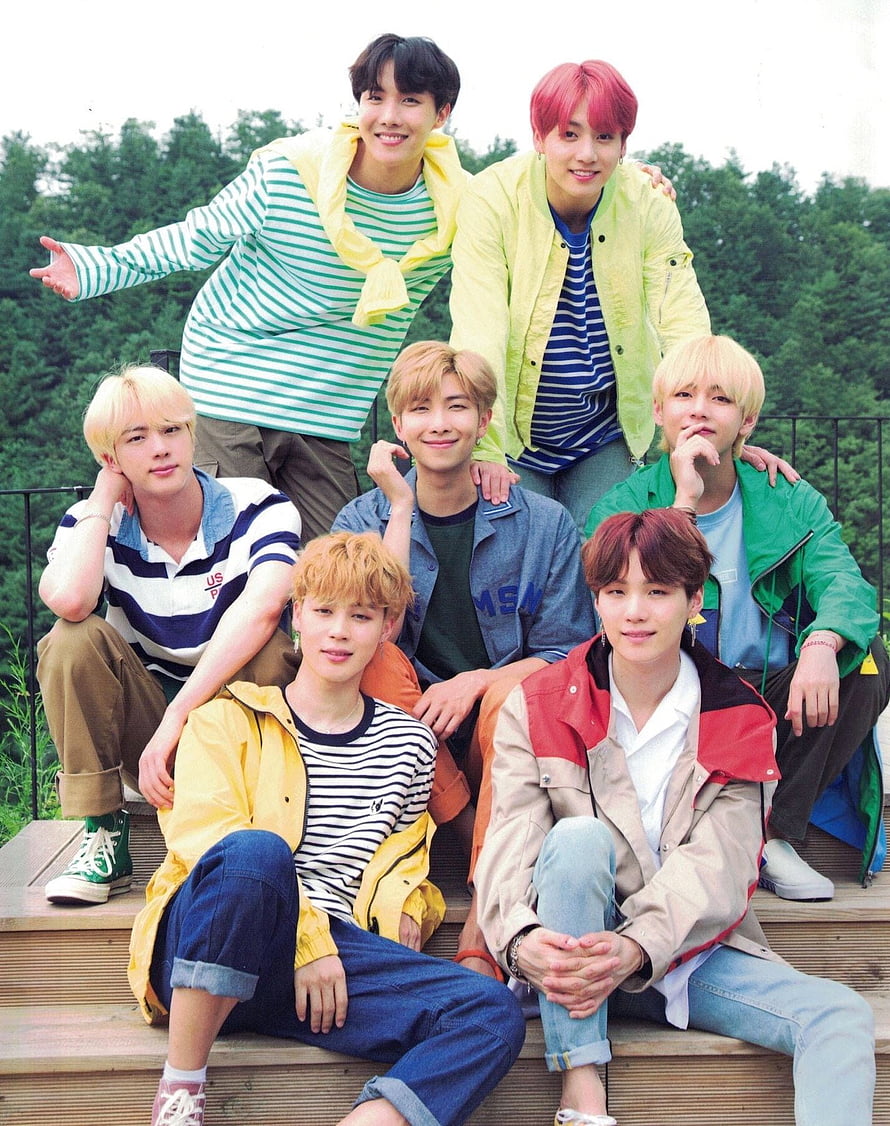 BTS Members Posing Together in Colorful Casual Outfits on Wooden Steps HD phone wallpaper