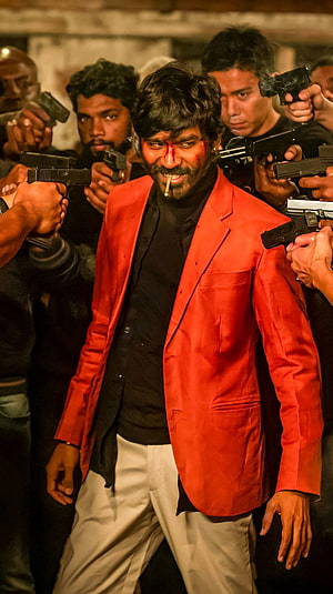 Danush in Jagame Thanthiram: Intense Action Scene with Guns and Red Suit HD phone wallpaper