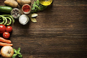 Rustic Wooden Table With Fresh Vegetables, Spices, and Herbs Arranged Along the Edge HD wallpaper