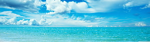 Serene Turquoise Ocean Horizon Under a Bright Blue Sky with Fluffy White Clouds HD wallpaper