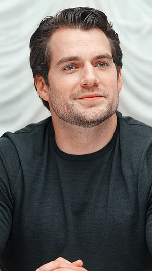 Henry Cavill Portrait in Black Shirt with Soft Studio Backdrop HD phone wallpaper