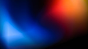 Vibrant Abstract Gradient with Soft Blue and Red Light Blurs on Dark Background HD wallpaper