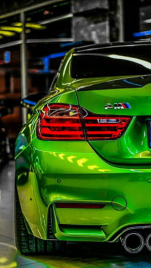 Rear View of a Vibrant Green BMW M4 Coupe with Sporty Exhaust and Taillights HD phone wallpaper