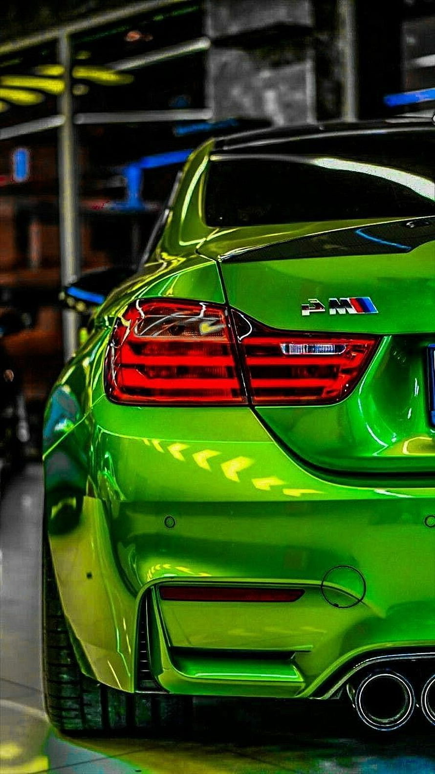 Rear View of a Vibrant Green BMW M4 Coupe with Sporty Exhaust and Taillights HD phone wallpaper