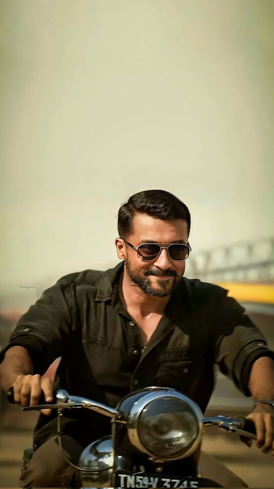 Surya Riding a Classic Motorcycle in a Black Shirt and Sunglasses HD phone wallpaper