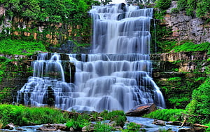 Majestic Tiered Waterfall Cascading Through Lush Green Forest Rocks HD wallpaper