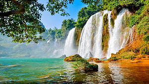 Majestic Tropical Waterfall Cascading Into Turquoise Lake Surrounded By Lush Jungle HD wallpaper