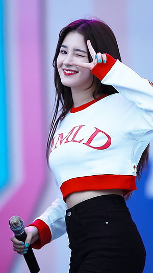Nancy from MAMAMOO performing on stage in a white and red crop top with a microphone HD phone wallpaper
