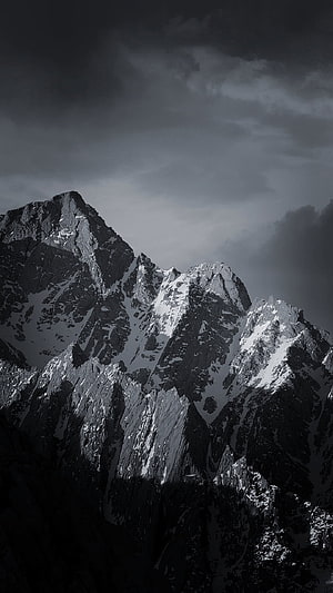 Monochrome Snow-Capped Mountain Peaks Under Dramatic Stormy Skies HD phone wallpaper