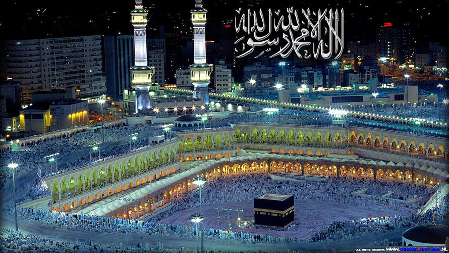 Aerial Night View of the Grand Mosque in Mecca with the Kaaba and Massive Pilgrim Crowds HD wallpaper