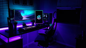 Vibrant RGB Gaming Setup With Dual Monitors And Neon Purple Ambient Lighting HD wallpaper