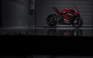 Ducati Superleggera V4 Red Sportbike Parked in Dark Industrial Garage Setting HD wallpaper
