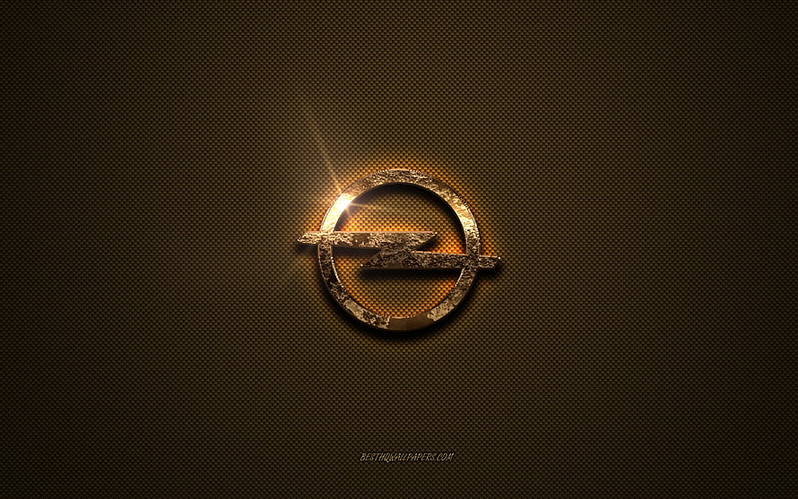 Opel Golden Emblem on Textured Brown Metal Surface with Dramatic Lighting HD wallpaper