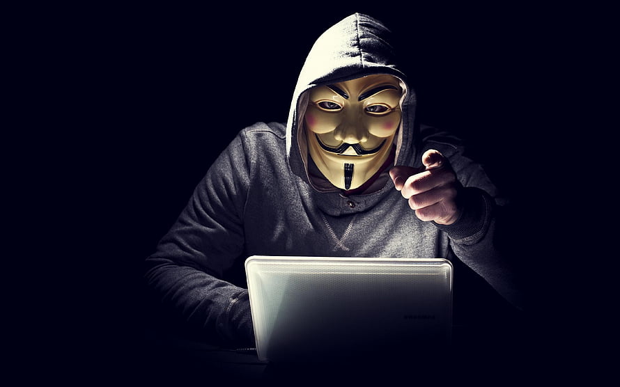 Anonymous Guy Fawkes Mask Hacker Pointing at Laptop in Dark Room HD wallpaper