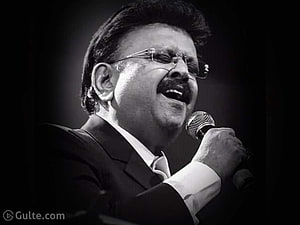 S. P. Balasubrahmanyam Singing Into Microphone in Black and White Portrait HD wallpaper