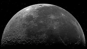 High-Resolution Black and White Close-Up of the Moon's Cratered Surface Against a Starry Night Sky HD wallpaper