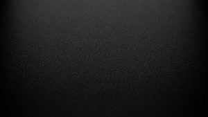 Minimalist Dark Grey Textured Surface with Subtle Vignette and Matte Finish HD wallpaper