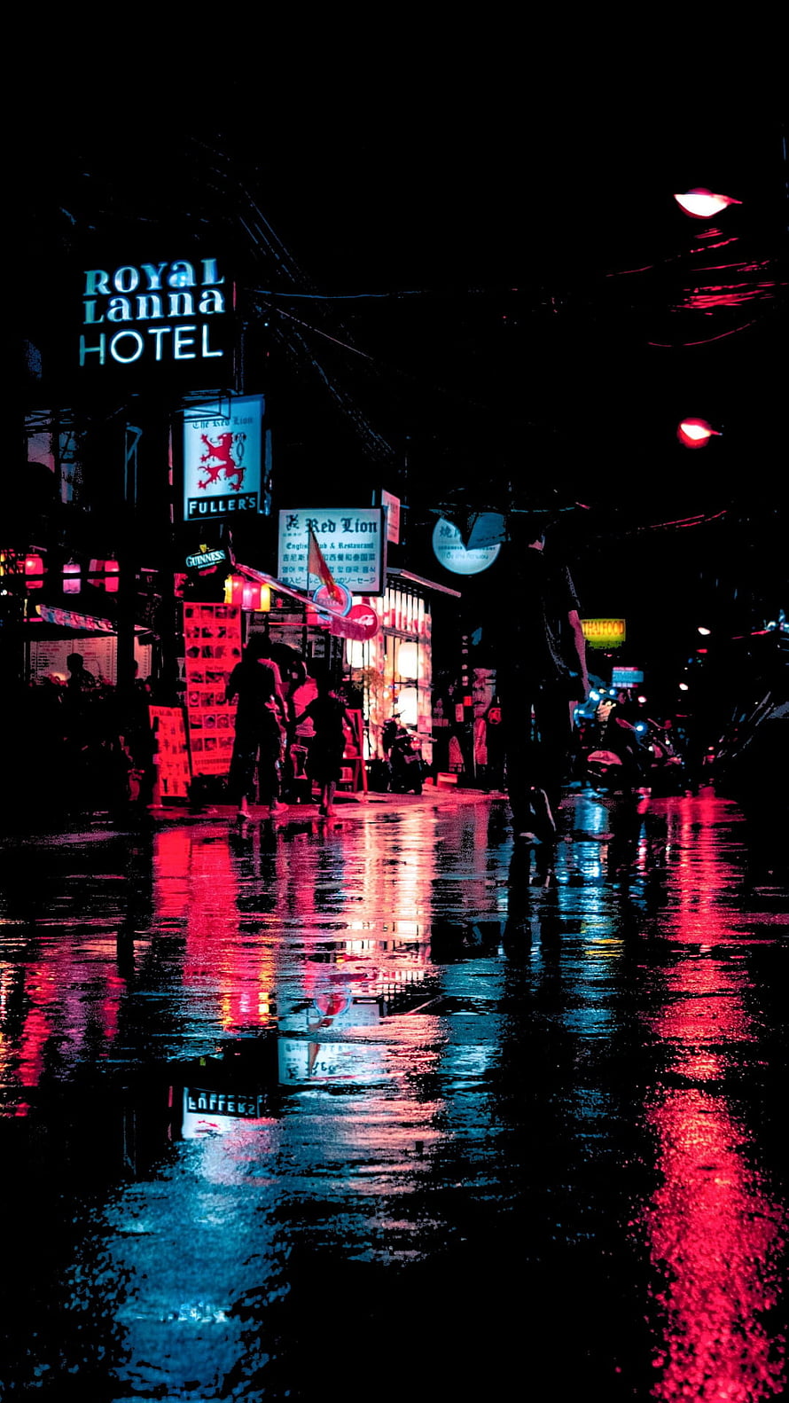 Neon-lit rainy street at night with vibrant red and blue reflections on wet pavement HD phone wallpaper
