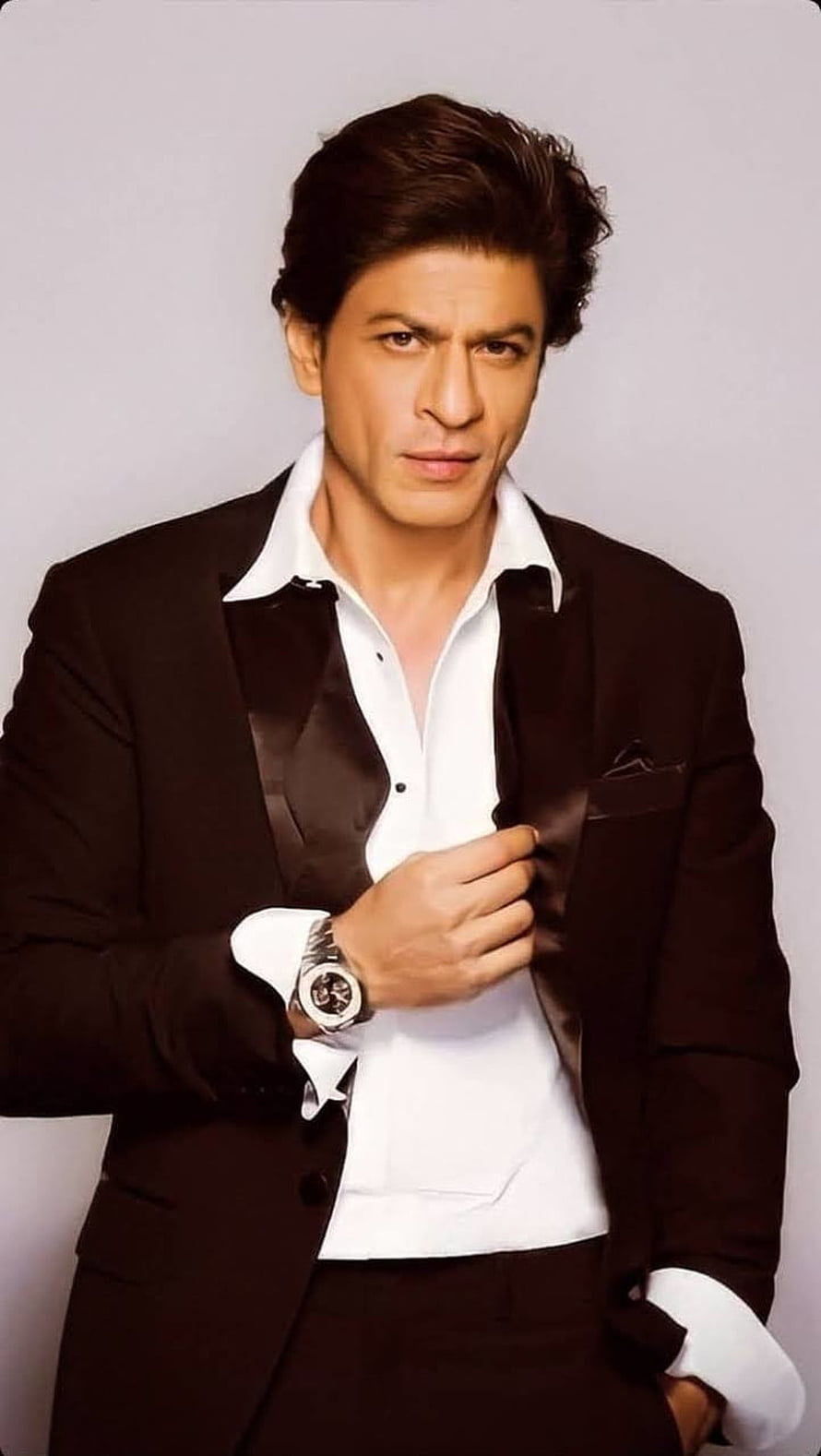 Shah Rukh Khan in a black tuxedo jacket and white shirt with a wristwatch HD phone wallpaper