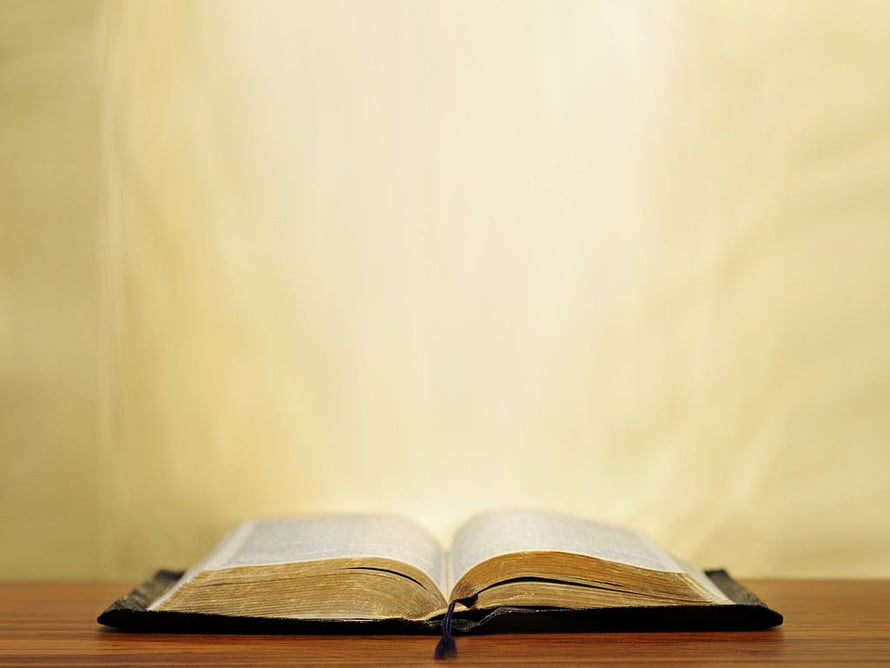 Open Bible on Wooden Table with Soft Warm Light and Minimalist Background HD wallpaper