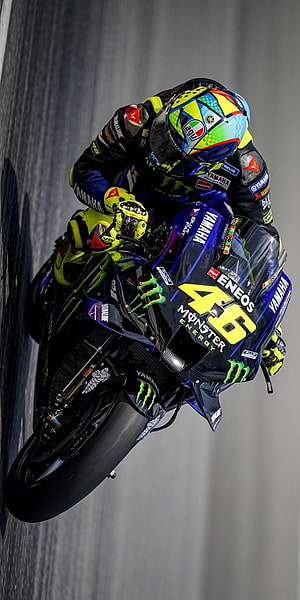 Yamaha MotoGP racer leaning into a corner on a race track HD phone wallpaper