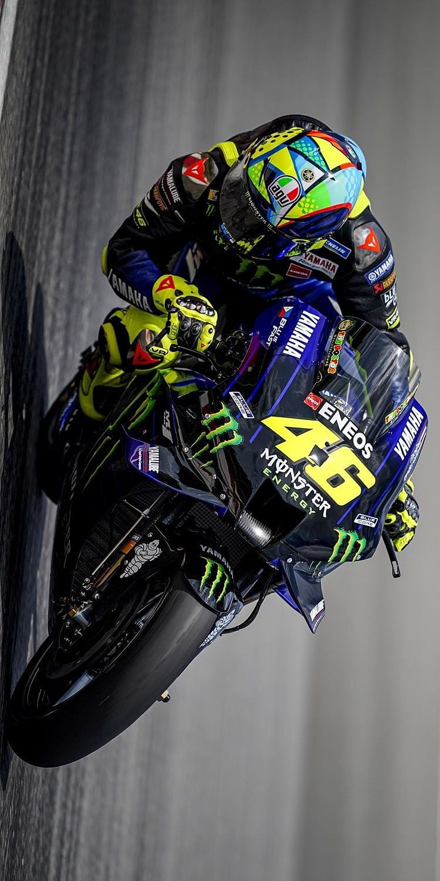 Yamaha MotoGP racer leaning into a corner on a race track HD phone wallpaper