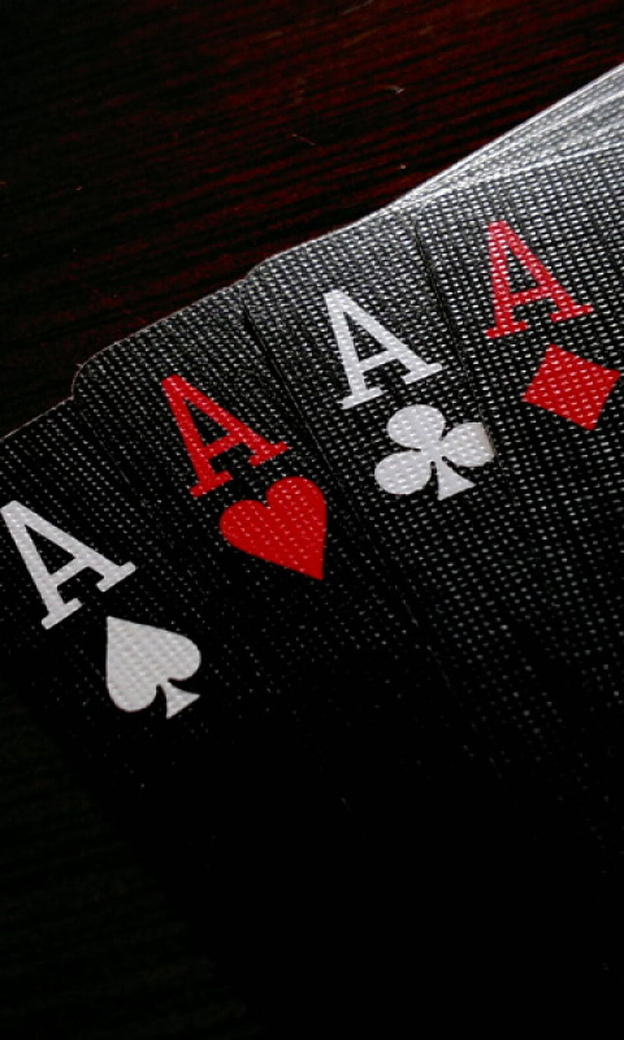 Four Aces Playing Cards Fanned on Dark Wooden Table with Red and White Suits HD phone wallpaper