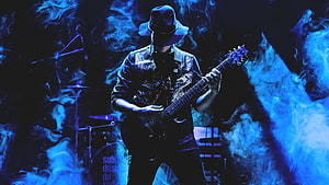 Gustavo Cerati performing live with electric guitar under blue stage smoke HD wallpaper