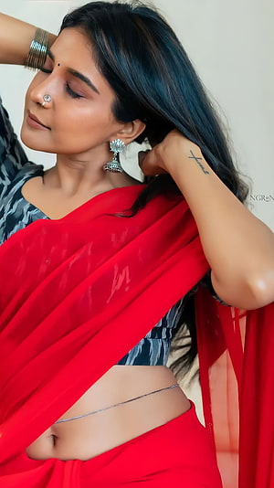 Sakshi Agarwal in a vibrant red saree with traditional silver jewelry and a delicate navel chain HD phone wallpaper