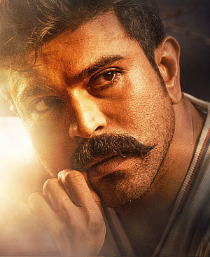 Ram Charan Intense Close-Up Portrait With Mustache And Dramatic Warm Lighting HD phone wallpaper