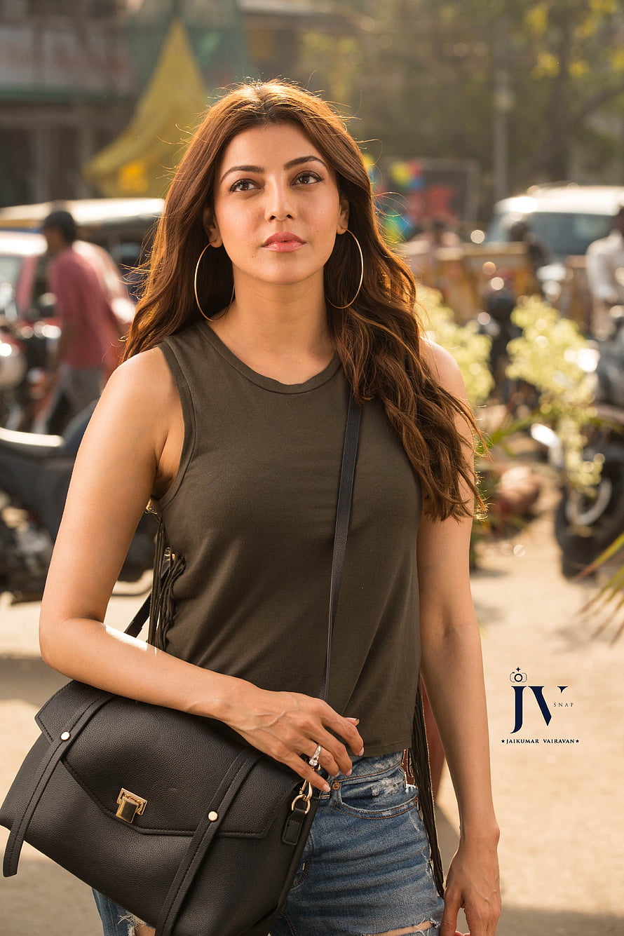 Kajal Agarwal in olive tank top and distressed denim with black crossbody bag HD phone wallpaper