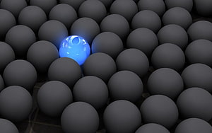Glowing Blue Sphere Amidst Dark Grey Balls in 3D Render HD wallpaper