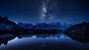 Milky Way Galaxy Over Snow-Capped Mountain Range Reflected in a Still Alpine Lake at Night HD wallpaper