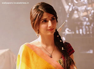 Hema in a yellow and red sari with a braided hairstyle and traditional jewelry HD wallpaper