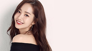 Park Min Young smiling portrait in black off-shoulder top with long wavy hair HD wallpaper