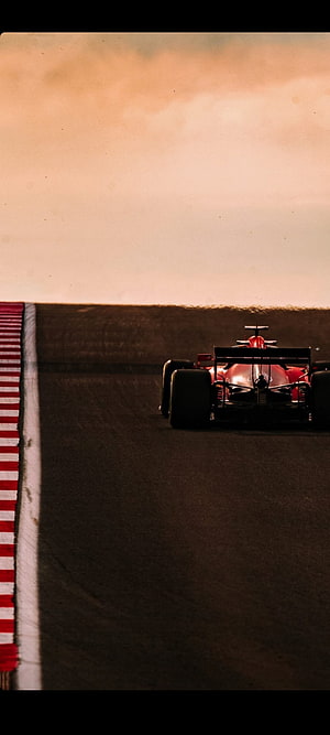 Charles Leclerc Scuderia Ferrari Formula 1 Car on the Race Track at Sunset HD phone wallpaper