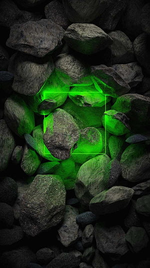 Glowing Green Neon Light Source Hidden Among Dark Rocks and Stones HD phone wallpaper