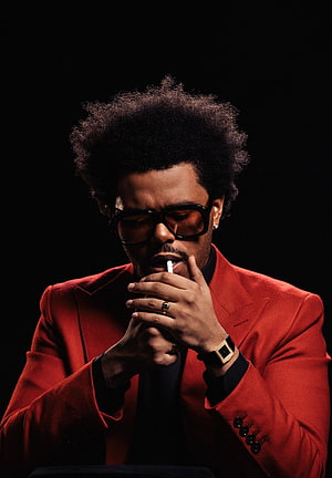 The Weeknd in a red suit with sunglasses and a cigarette against a black background HD phone wallpaper