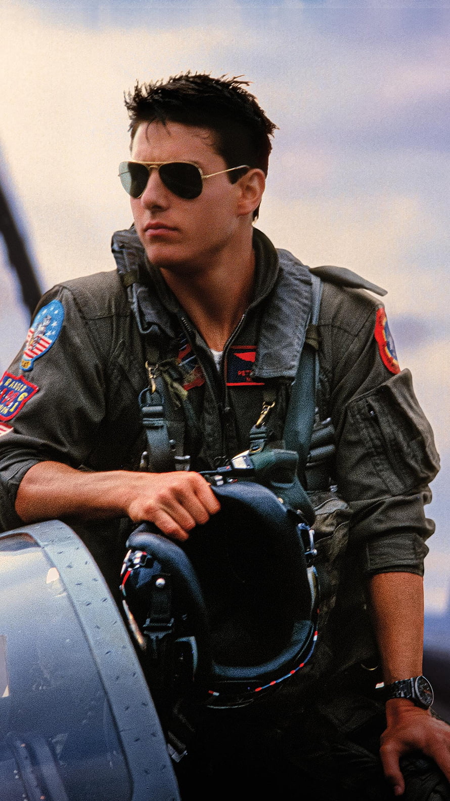 Tom Cruise as Maverick in Top Gun wearing aviator sunglasses and flight suit HD phone wallpaper