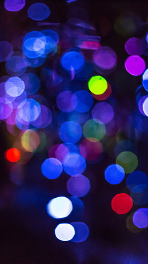 Vibrant Bokeh Light Orbs in Blue, Purple, and Green Against a Dark Night Sky HD phone wallpaper