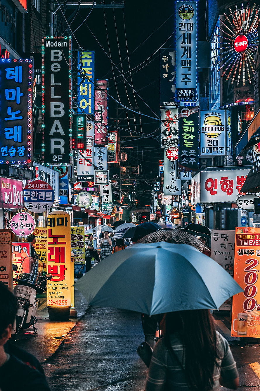 Rainy Night in Myeongdong Seoul with Neon Signs and Umbrellas HD phone wallpaper