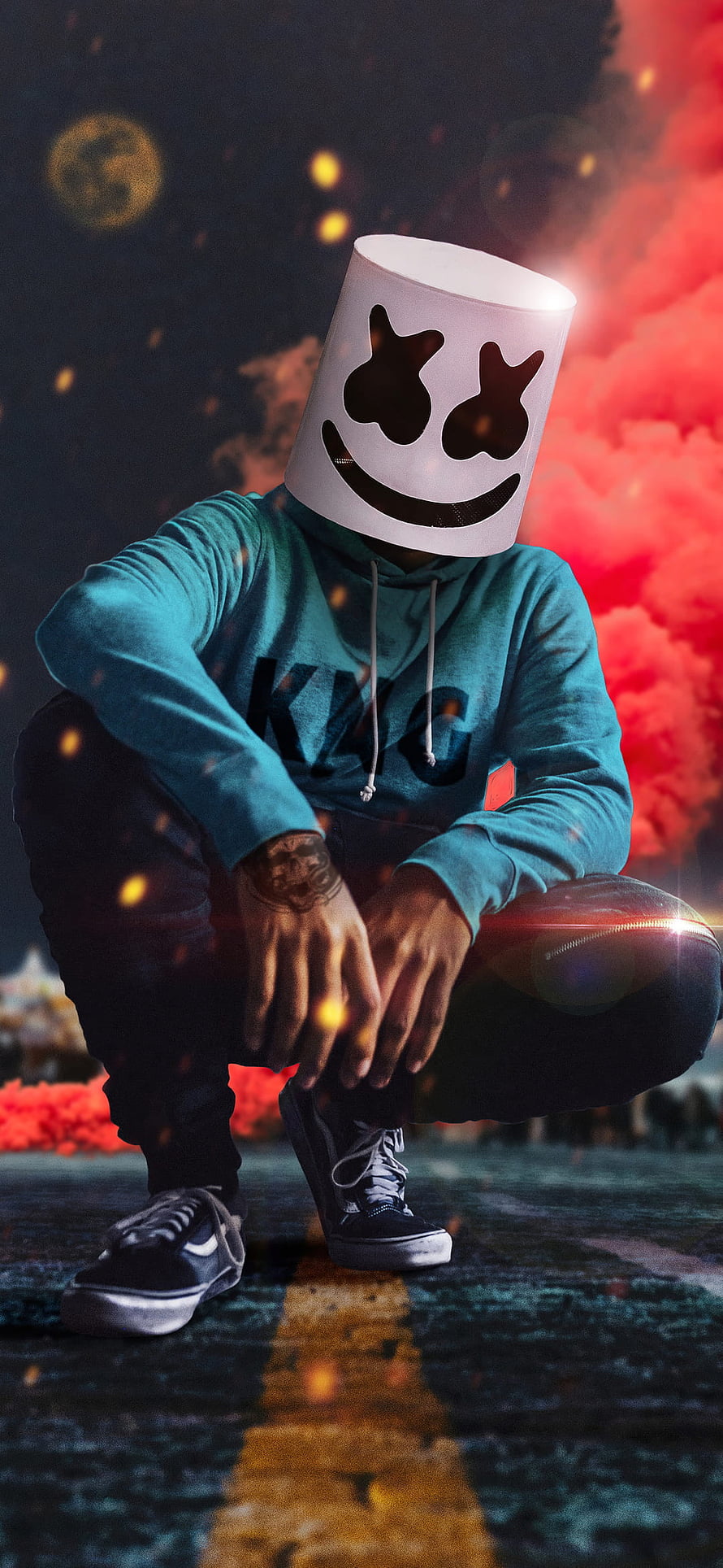 Marshmello Crouching in Teal Hoodie Against Fiery Red Smoke and Embers HD phone wallpaper