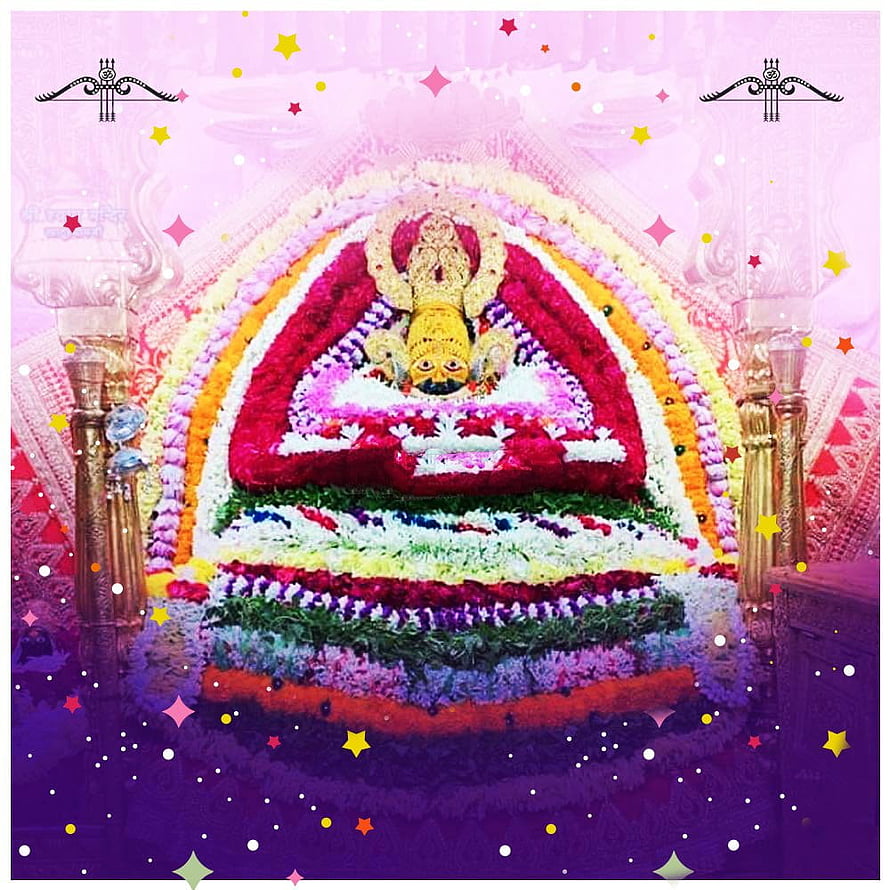 Khatu Shyam Baba adorned with vibrant floral garlands and decorative arches in a temple setting HD phone wallpaper