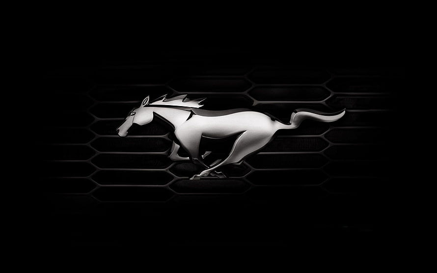 Sleek Silver Ford Mustang Pony Emblem on Dark Hexagonal Grille Background HD wallpaper