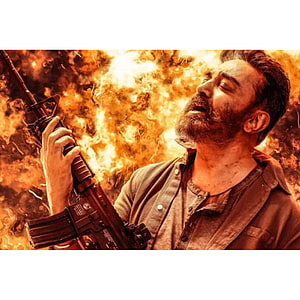 Kamal Haasan as Vikram holding rifle against fiery explosion backdrop HD phone wallpaper