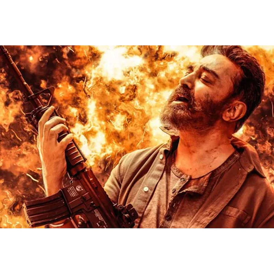 Kamal Haasan as Vikram holding rifle against fiery explosion backdrop HD phone wallpaper