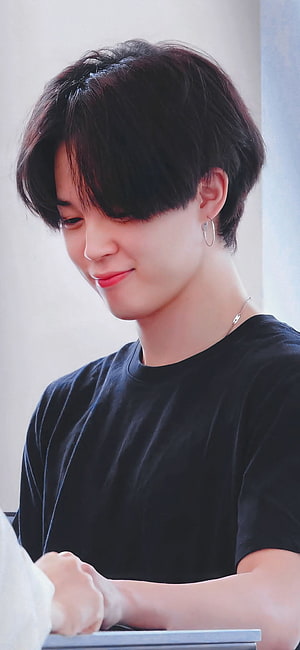 Jimin from BTS in a black t-shirt with hoop earrings and a gentle smile HD phone wallpaper