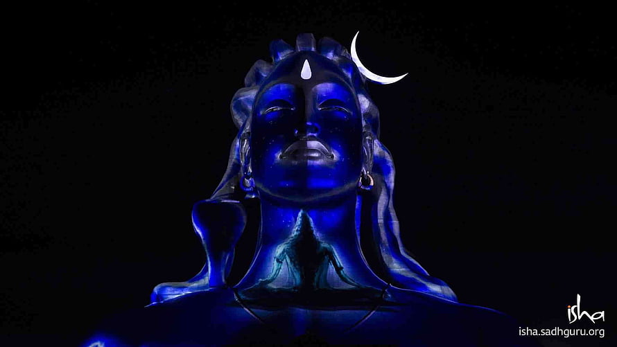 Adiyogi Statue Illuminated in Deep Blue with Crescent Moon and Isha Foundation Mark HD wallpaper